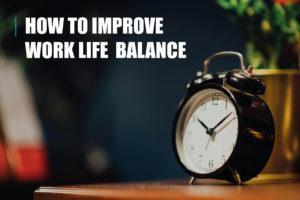Analogue alarm clock in foreground, with blurred indistinct household items in the background. Image includes the text "how to improve work life balance"