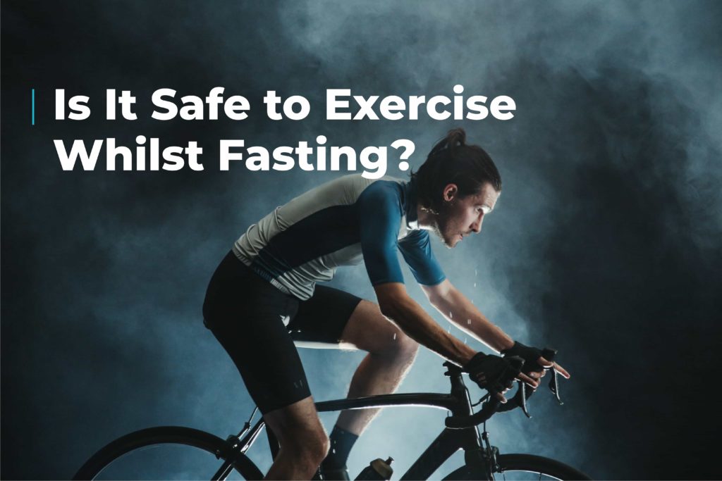 Sweating man in cycling clothes sat on a sports bike. Image includes the caption "is it safe to exercise whilst fasting?"